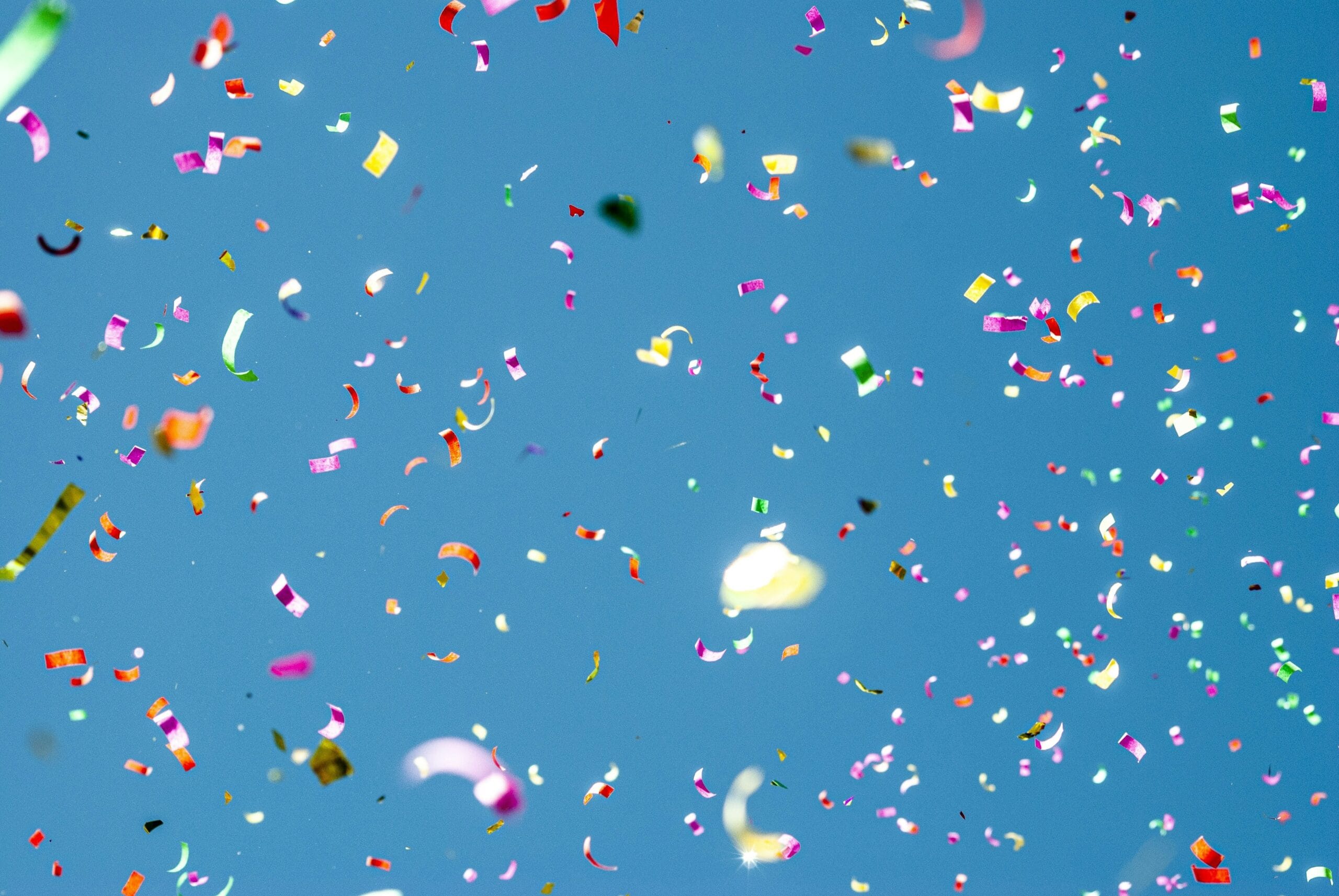 Confetti thrown against a blue background.