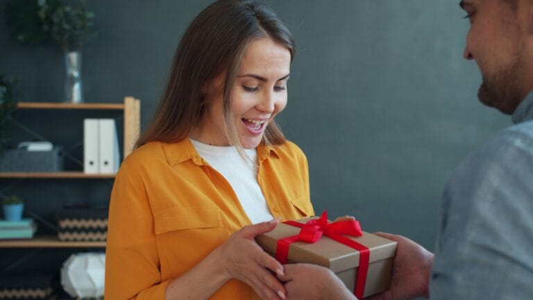 Woman receiving a gift, gifts for book lovers.