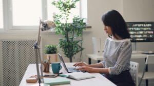 Woman writing in a computer.