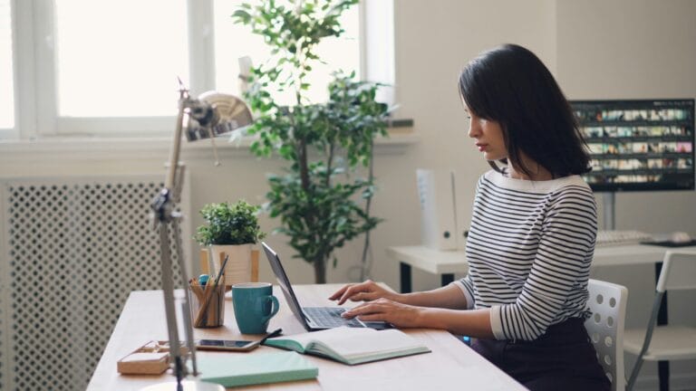 Woman writing in a computer.